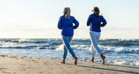 Middle-aged woman running on beach